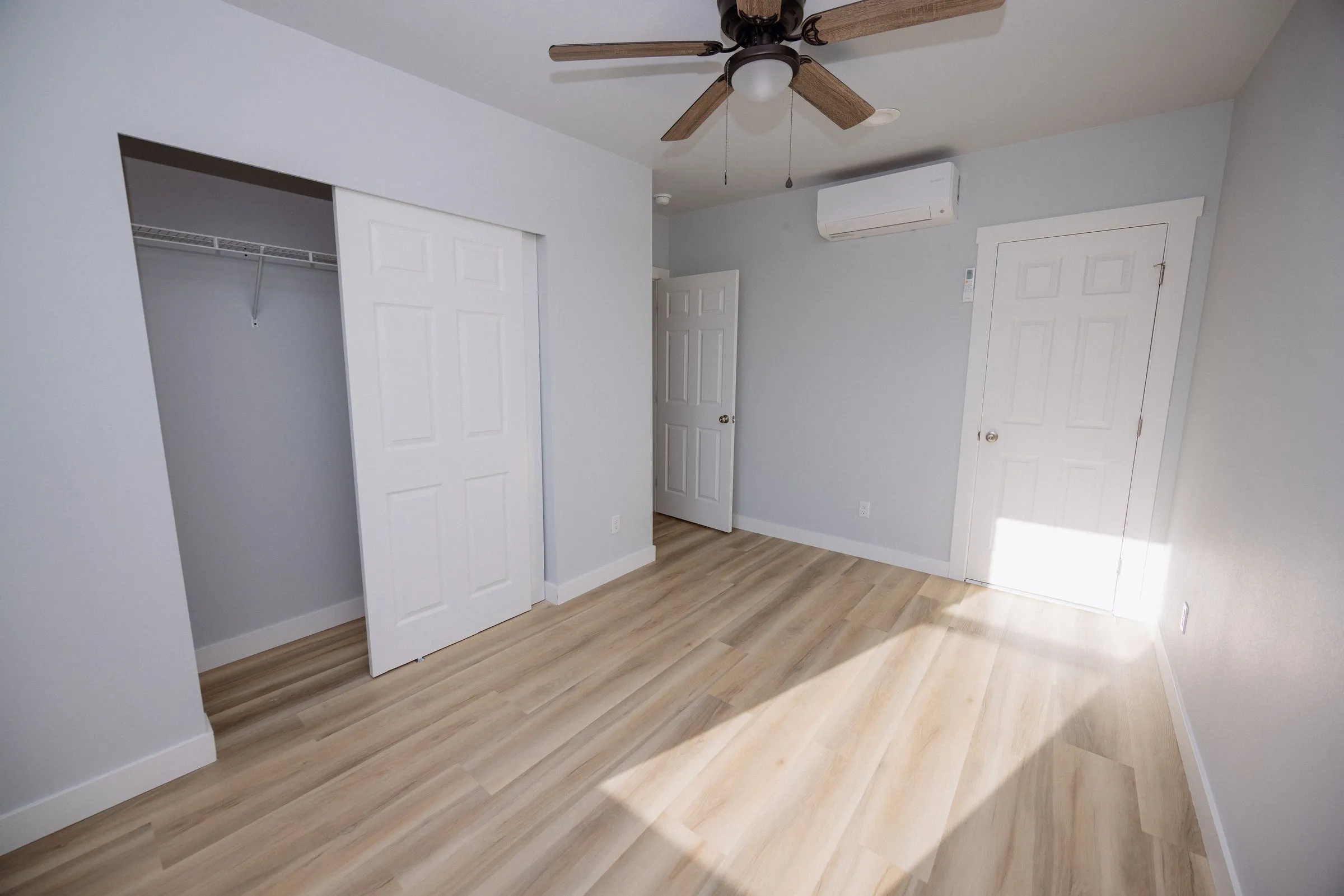 Second bedroom with a full-width closet, ceiling fan and its own mini-split head